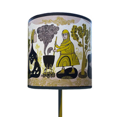 Lush designs lampshade on a lamp featuring print of medeival woman stirring a pot 