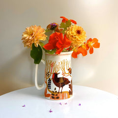 bird printed jug full of garden flowers