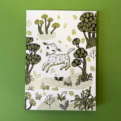 card with picture of frolicking lamb and bushes and plants