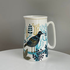 small jug with patterned bird and trees